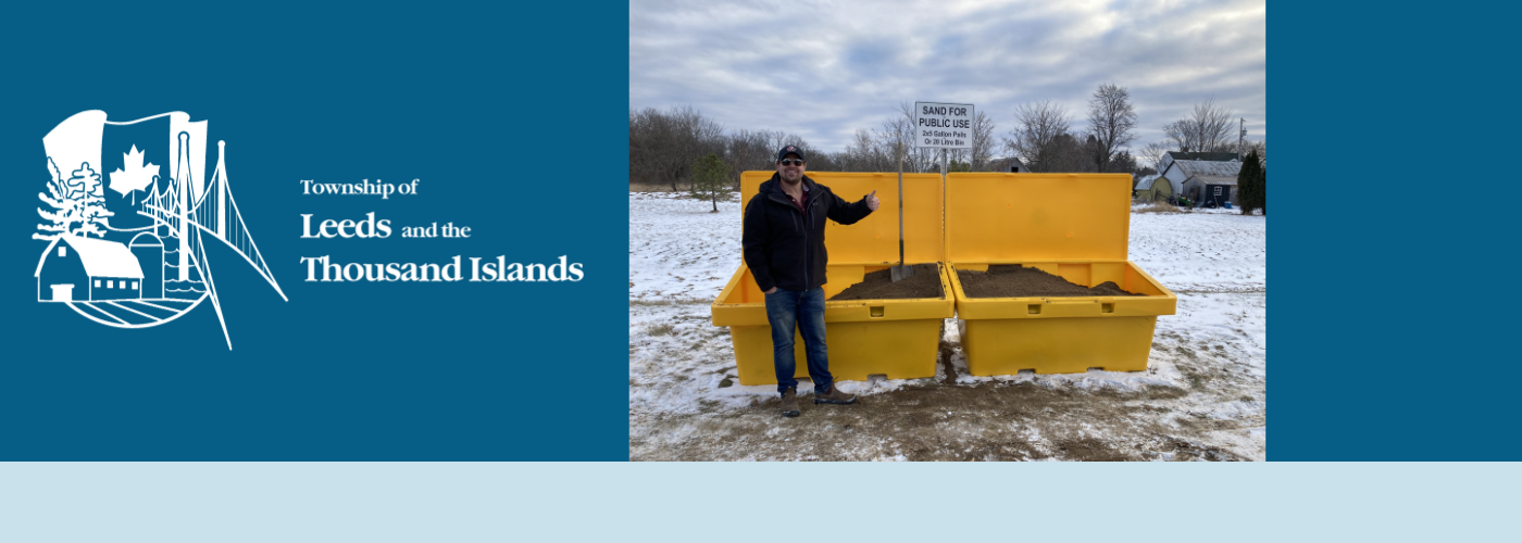 Picture of staff standing in front of a sand bin