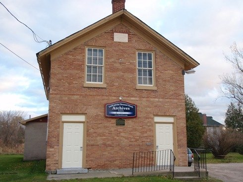 LTI Archives building.  A red brick two story building with two windows on the second level floor and two doors on the main level